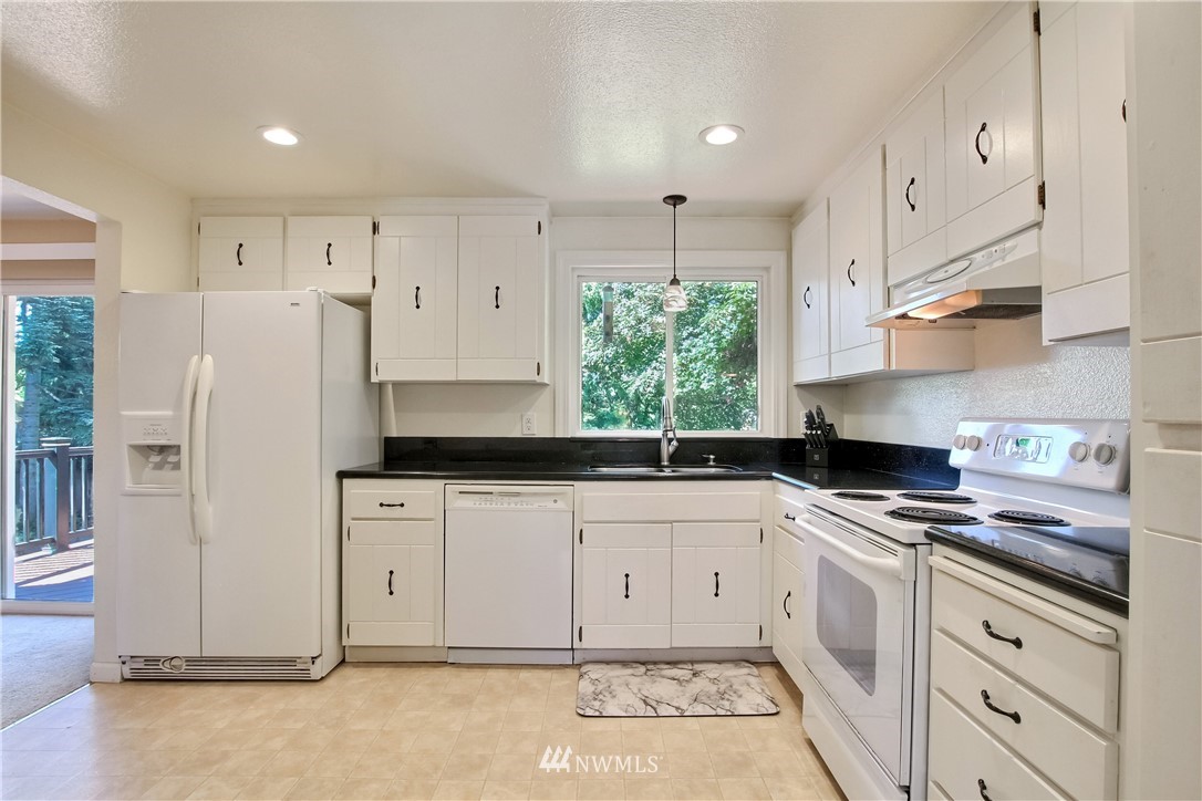 509 223rd Street Southwest Bothell, WA 98021 - Photo 10 of 39 a kitchen with granite countertop a sink stainless steel appliances and cabinets