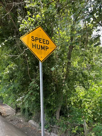 a sign broad in front of tree
