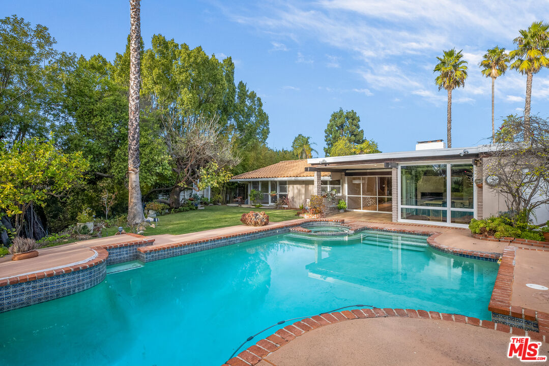 2255 Stradella Road Los Angeles, CA 90077 - Photo 2 of 33 swimming pool view with a seating space and a garden view