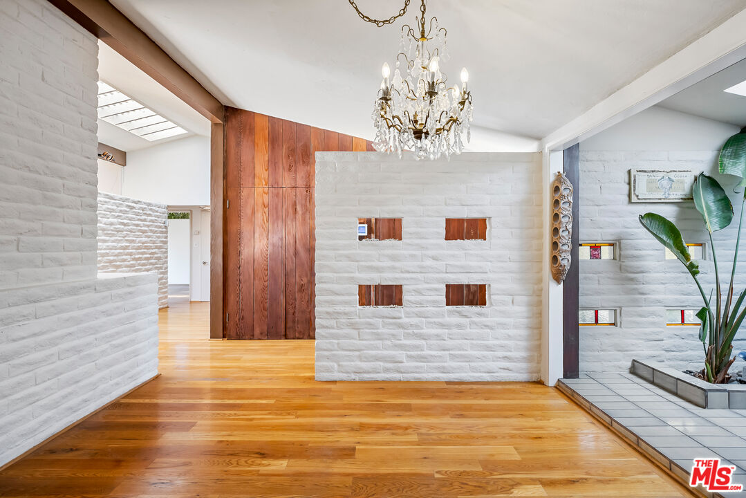 2255 Stradella Road Los Angeles, CA 90077 - Photo 14 of 33 a view of a hallway with a chandelier