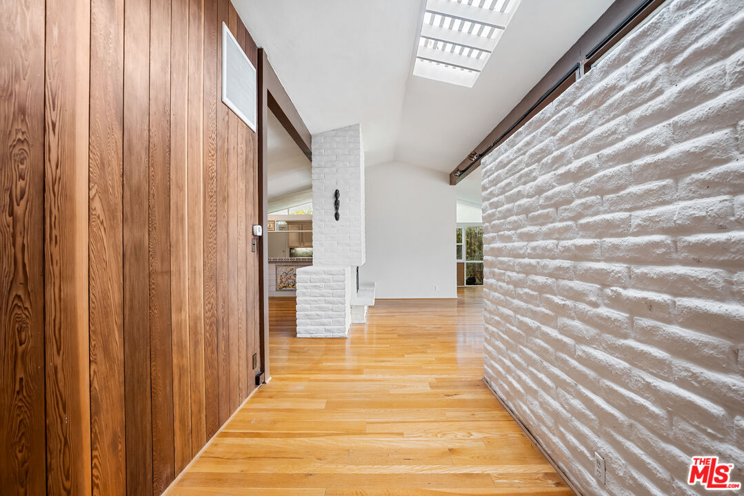 2255 Stradella Road Los Angeles, CA 90077 - Photo 18 of 33 a view of a hallway with wooden floor and staircase