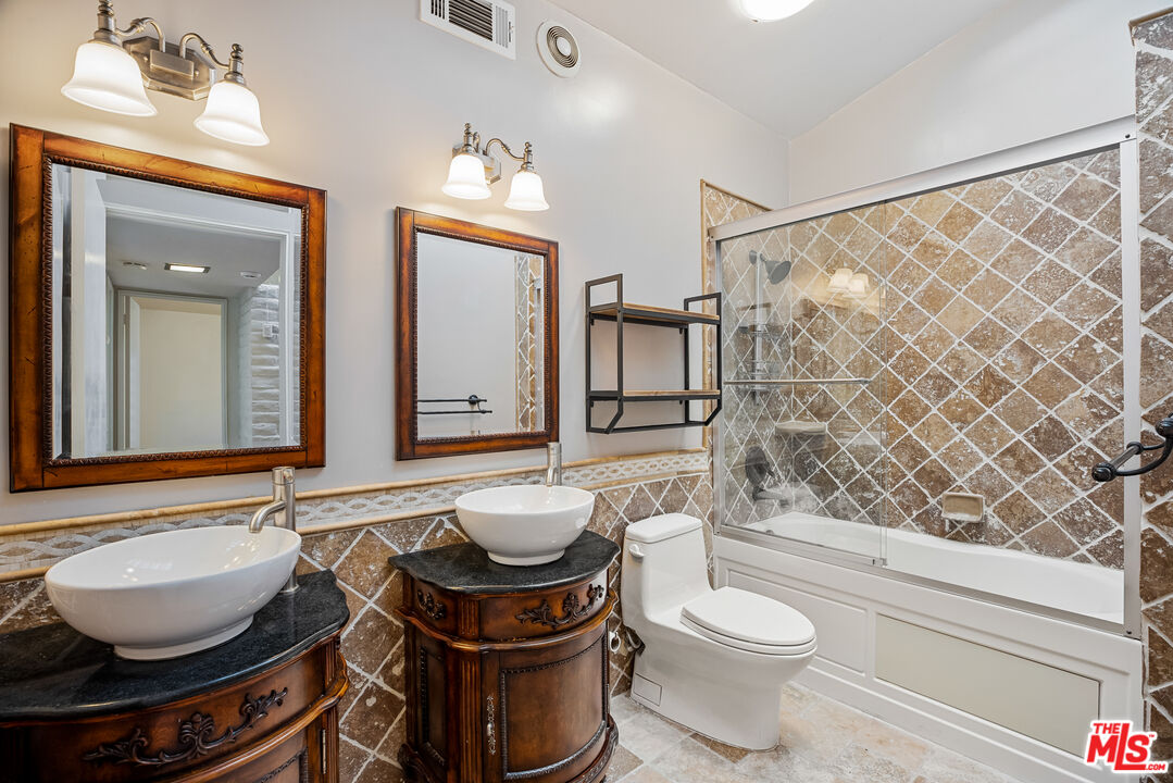2255 Stradella Road Los Angeles, CA 90077 - Photo 21 of 33 a bathroom with a toilet a sink and a mirror