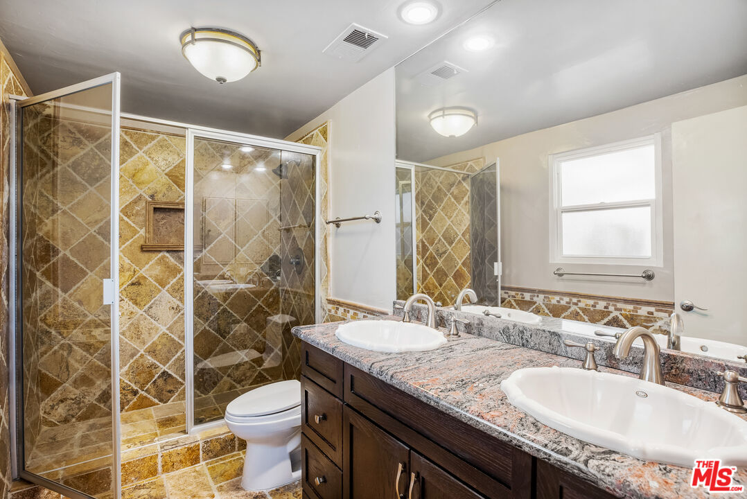 2255 Stradella Road Los Angeles, CA 90077 - Photo 23 of 33 a bathroom with a granite countertop sink toilet a mirror and shower