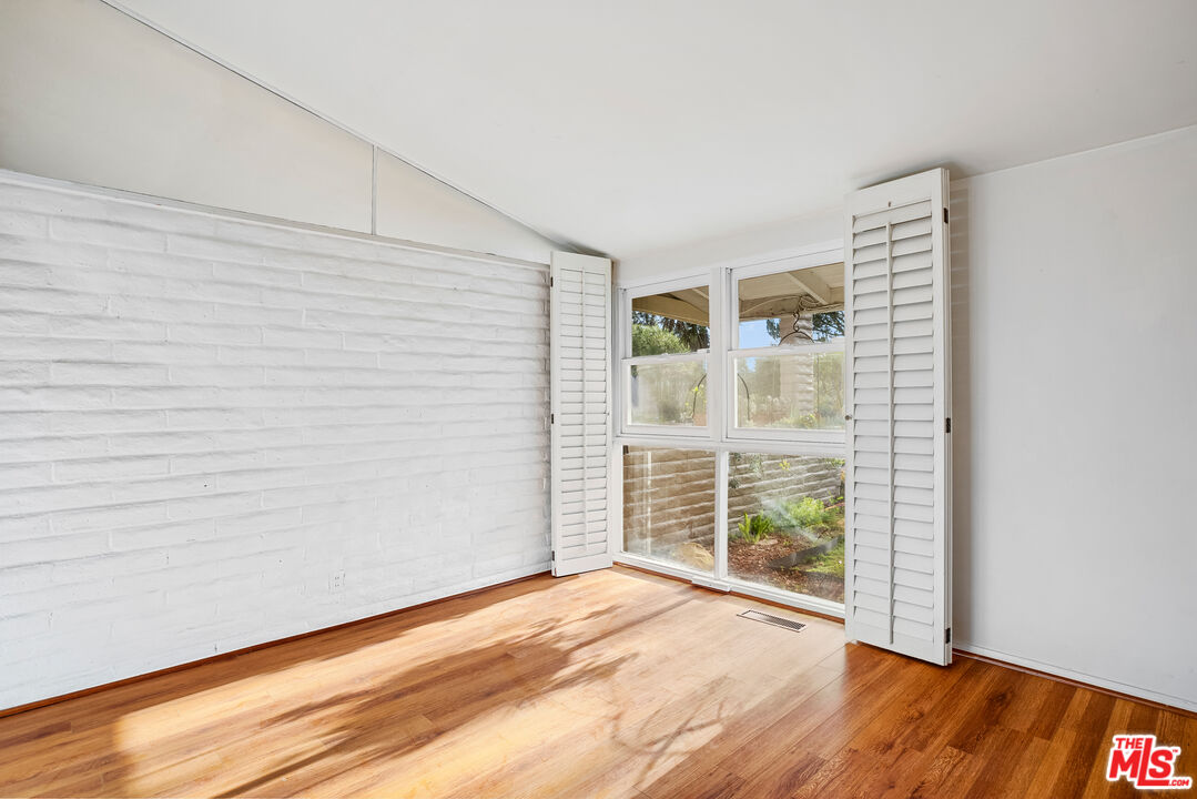 2255 Stradella Road Los Angeles, CA 90077 - Photo 24 of 33 a view of an empty room with wooden floor and a window