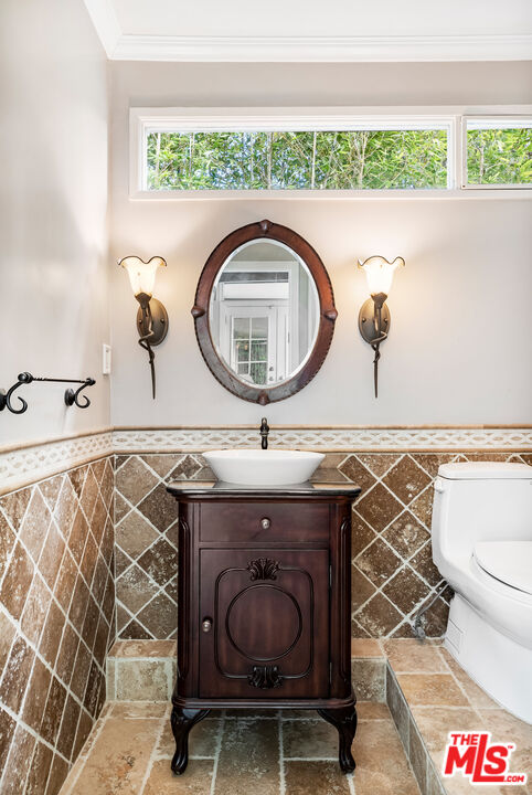 2255 Stradella Road Los Angeles, CA 90077 - Photo 25 of 33 a bathroom with a sink and a mirror