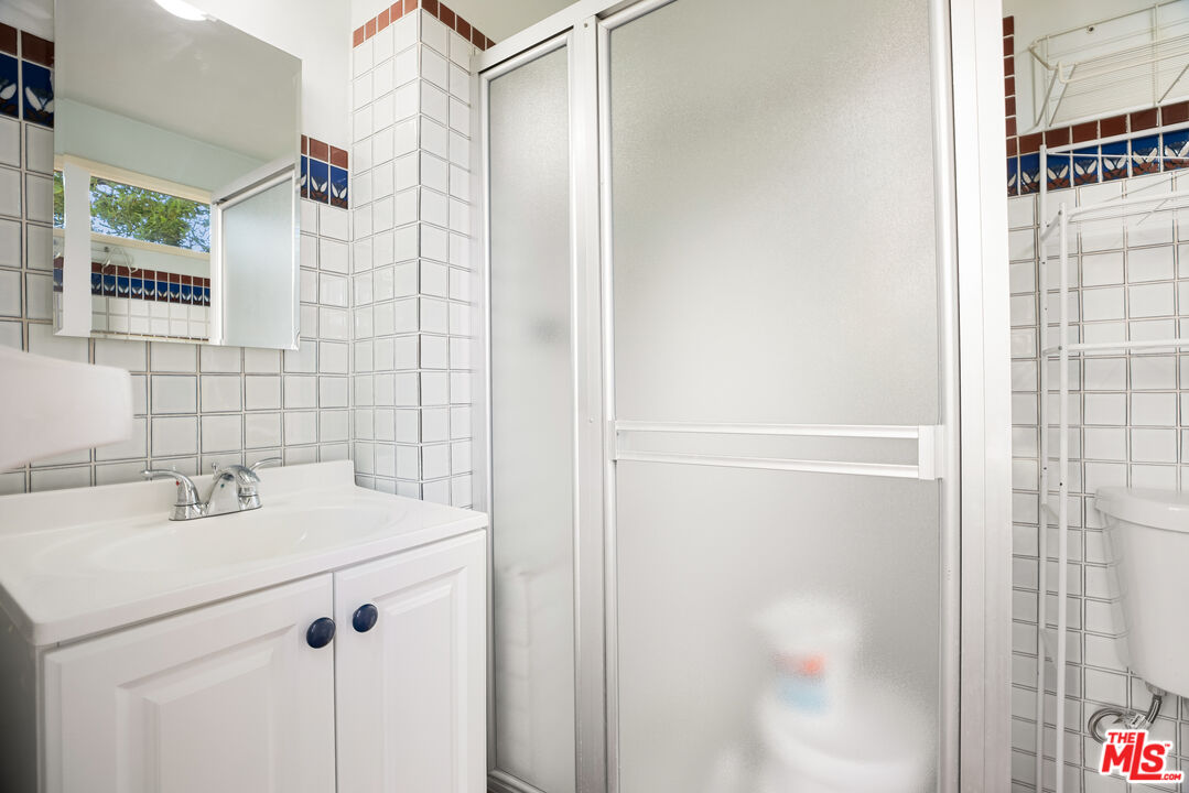 2255 Stradella Road Los Angeles, CA 90077 - Photo 27 of 33 a bathroom with a sink and a mirror