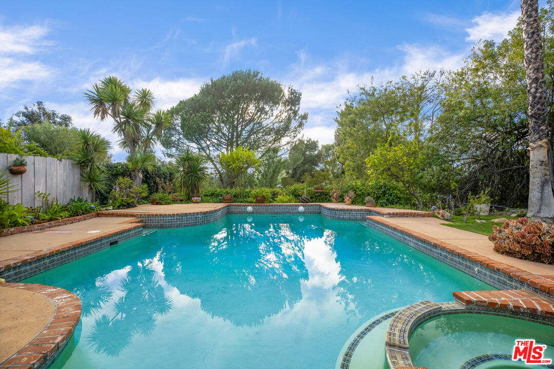 2255 Stradella Road Los Angeles, CA 90077 - Photo 29 of 33 a view of a swimming pool with a yard