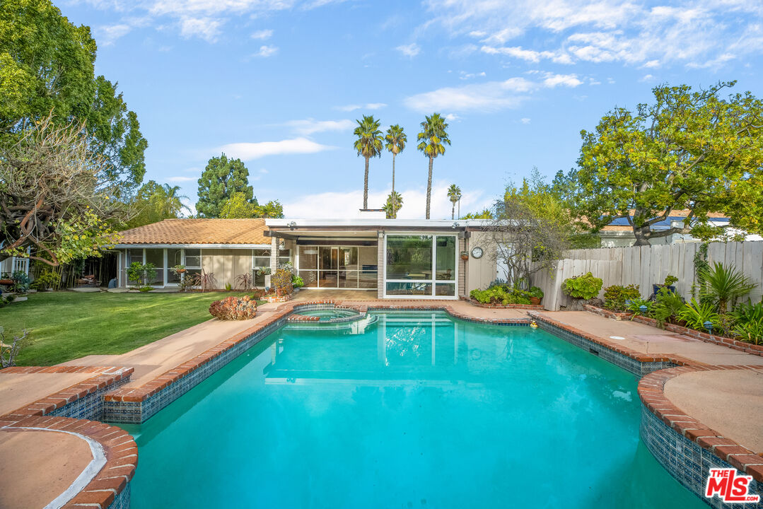 2255 Stradella Road Los Angeles, CA 90077 - Photo 31 of 33 a view of a house with swimming pool and yard