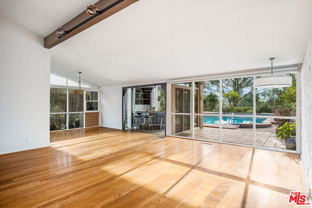 2255 Stradella Road Los Angeles, CA 90077 - Photo 5 of 33 a view of an empty room with wooden floor and a window