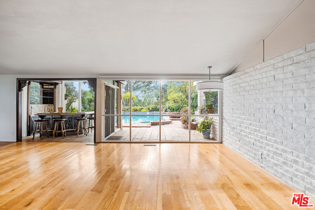 2255 Stradella Road Los Angeles, CA 90077 - Photo 7 of 33 a view of a room with wooden floor and furniture
