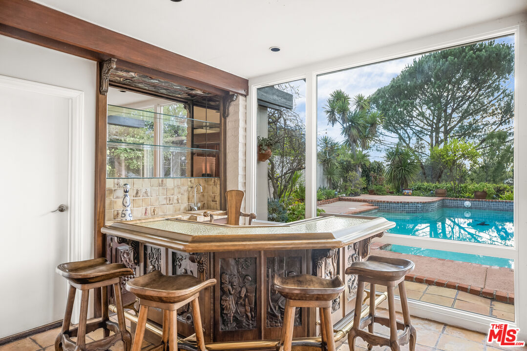 2255 Stradella Road Los Angeles, CA 90077 - Photo 10 of 33 a view of an outside dining space with furniture and wooden floor