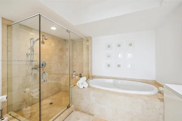 a bathroom with a bathtub and shower