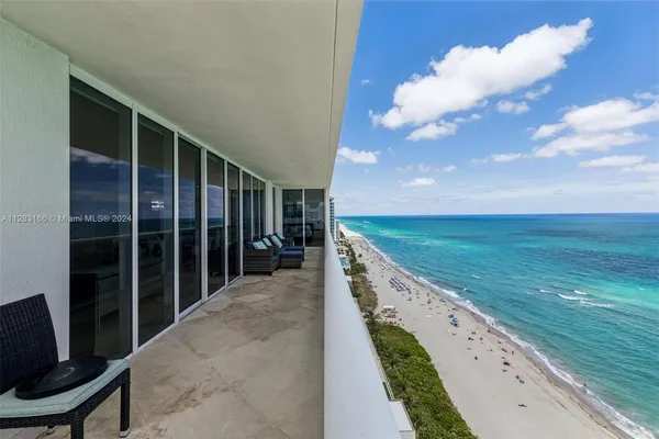 a view of a balcony with an ocean