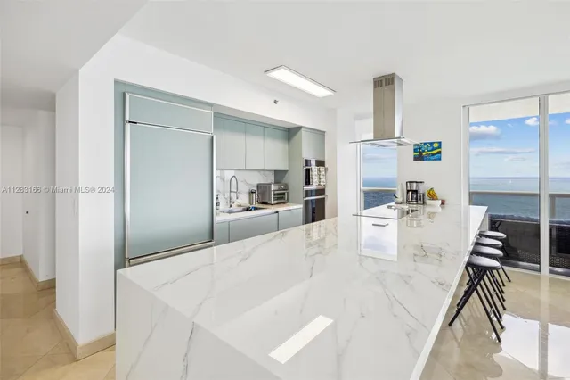 a view of kitchen with furniture and refrigerator