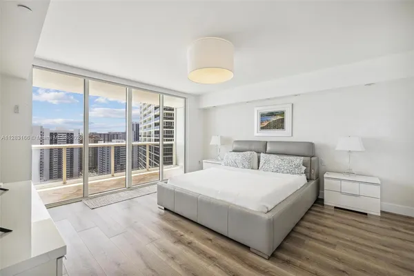 a bedroom with a large bed and a large window