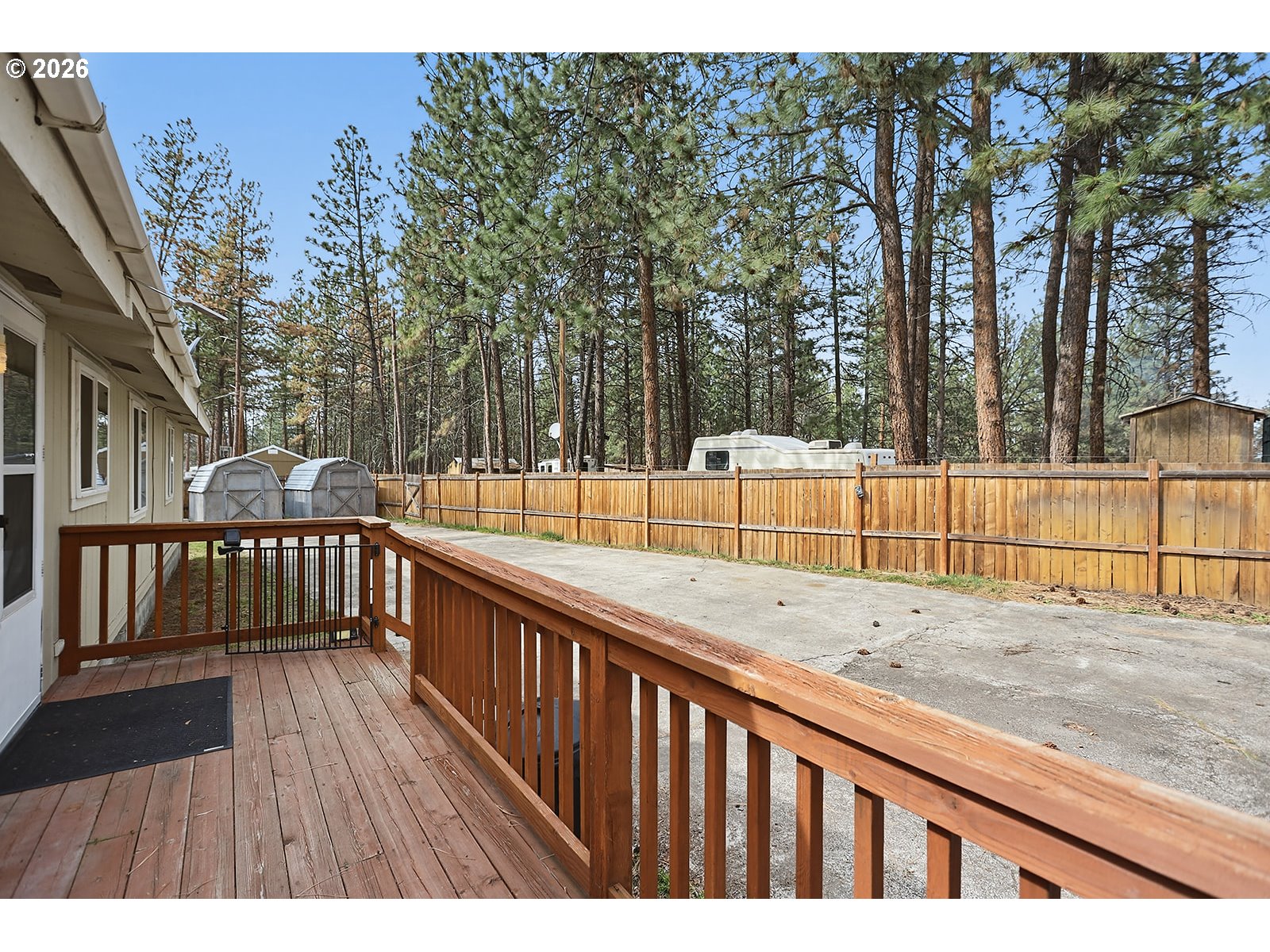 39 North Eagle Point Road Tygh Valley, OR 97063 - Photo 27 of 35 a view of deck with large trees and wooden fence