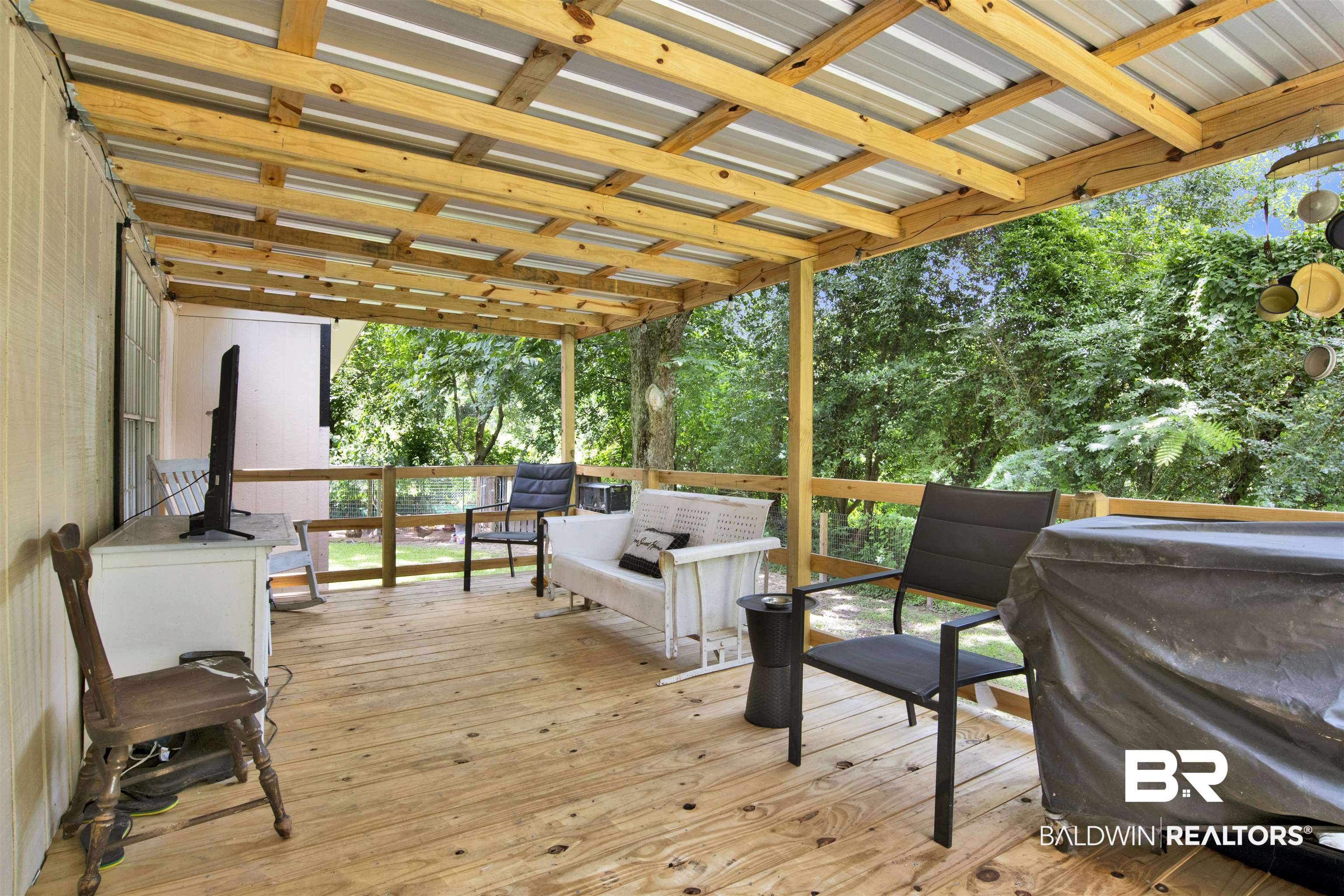 4265 Greaves Road Eight Mile, AL 36613 - Photo 23 of 34 Wooden deck with grilling area, view of scattered trees, and outdoor lounge area