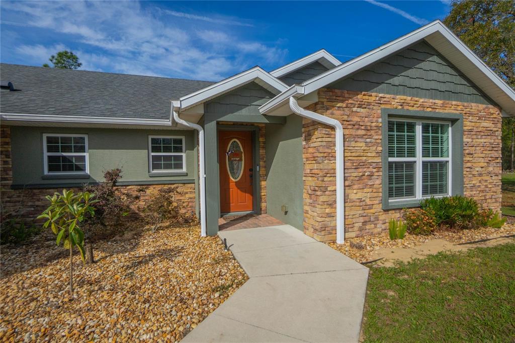 5466 West Tortuga Loop Lecanto, FL 34461 - Photo 5 of 41 a front view of a house with garden