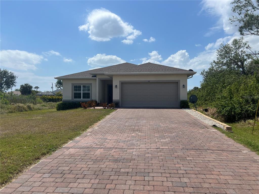 a front view of a house with a yard and garage
