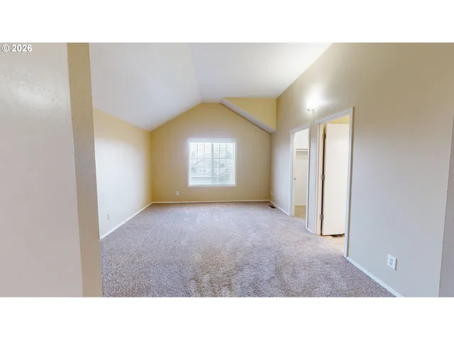a open living room with a window and a fireplace