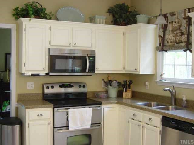 5252 Fairmead Circle Raleigh, NC 27613 - Photo 2 of 12 The kitchen features all new stainless steel appliances, including an electric range with dual ovens, microwave & a dishwasher. The built-in wine cooler is great for entertaining guests. Utility room is conveniently located by kitchen. Other