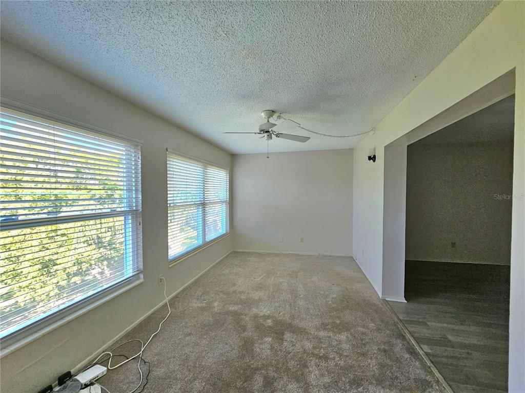 2457 Ecuadorian Way, Unit 75 Clearwater, FL 33763 - Photo 11 of 62 a view of an empty room with a window