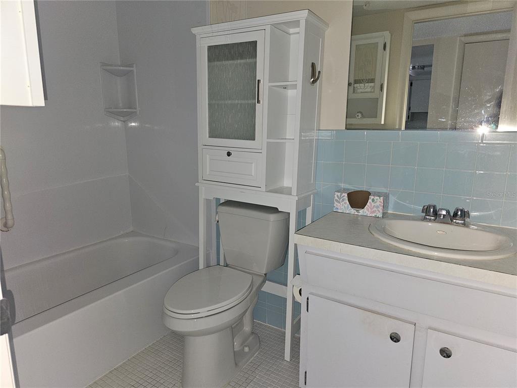 2457 Ecuadorian Way, Unit 75 Clearwater, FL 33763 - Photo 14 of 62 a bathroom with a sink toilet and shower