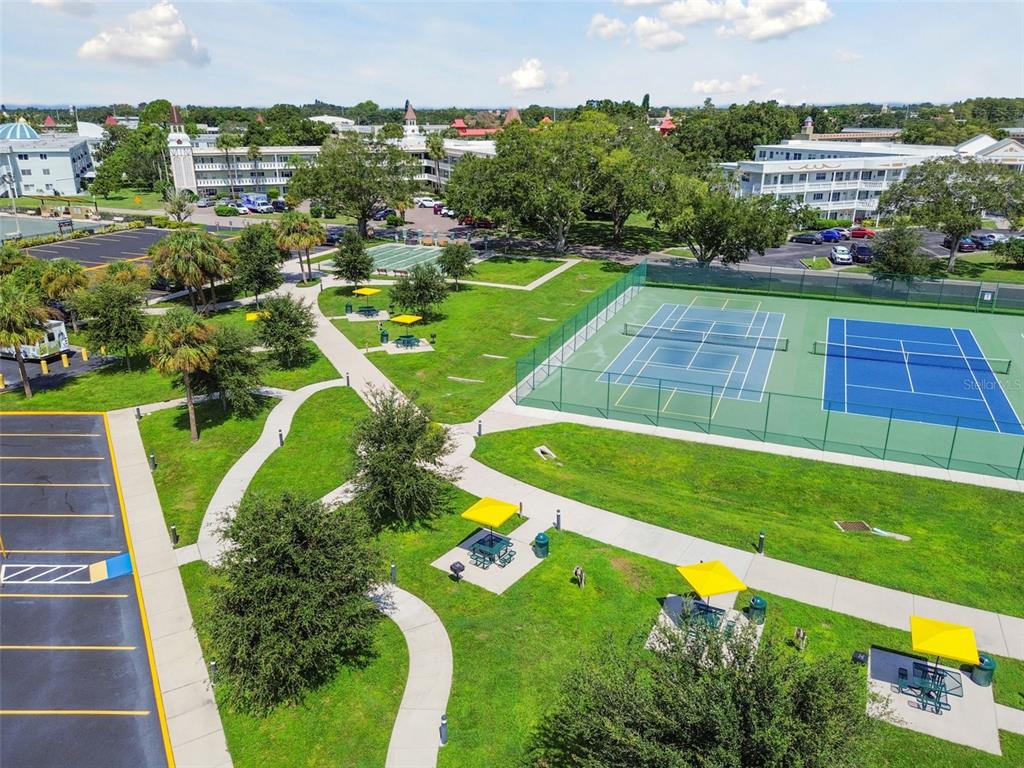 2457 Ecuadorian Way, Unit 75 Clearwater, FL 33763 - Photo 24 of 62 a view of a swimming pool with a yard and plants