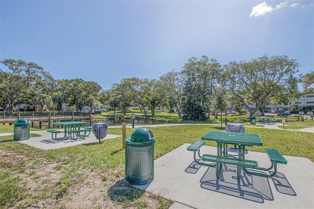 2457 Ecuadorian Way, Unit 75 Clearwater, FL 33763 - Photo 39 of 62 a view of a lake with table and chairs