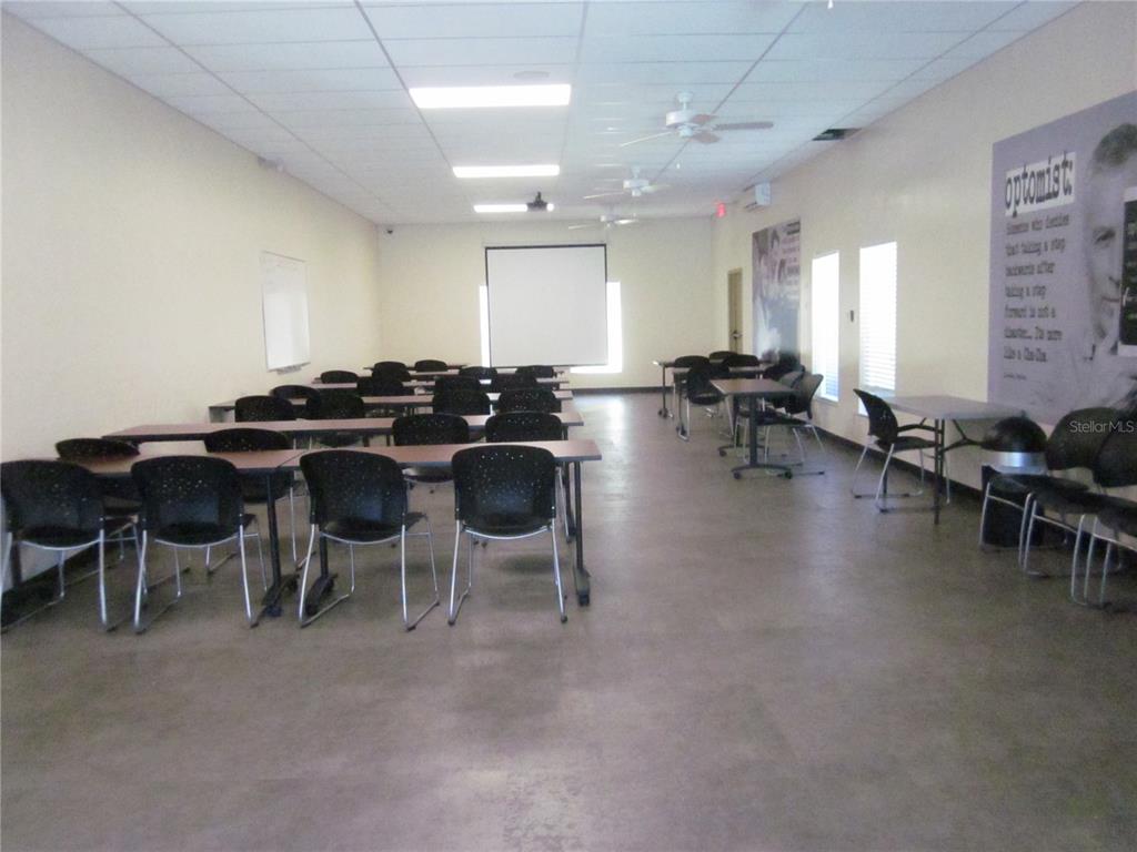 2457 Ecuadorian Way, Unit 75 Clearwater, FL 33763 - Photo 55 of 62 a kitchen with lots of table and chairs