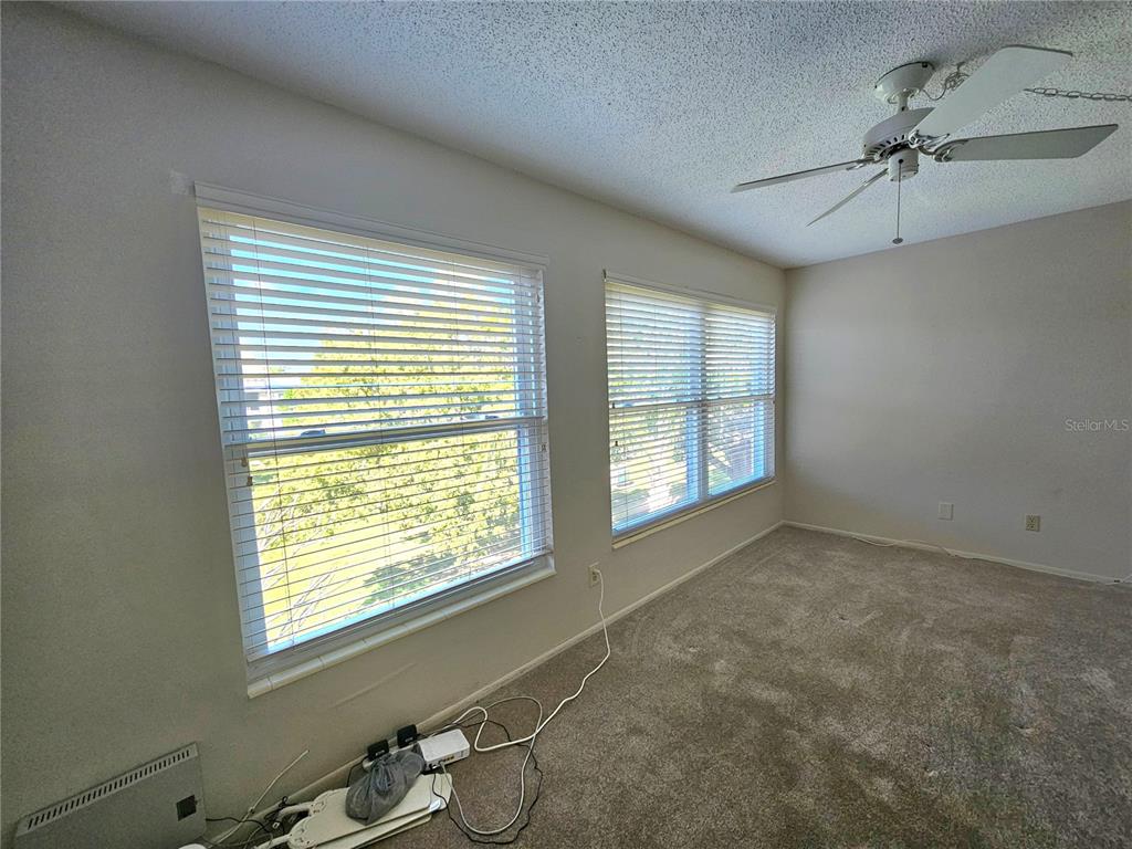 2457 Ecuadorian Way, Unit 75 Clearwater, FL 33763 - Photo 10 of 62 a view of an empty room with a window