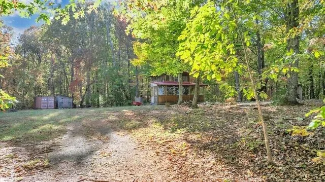 a view of a house with yard and a tree