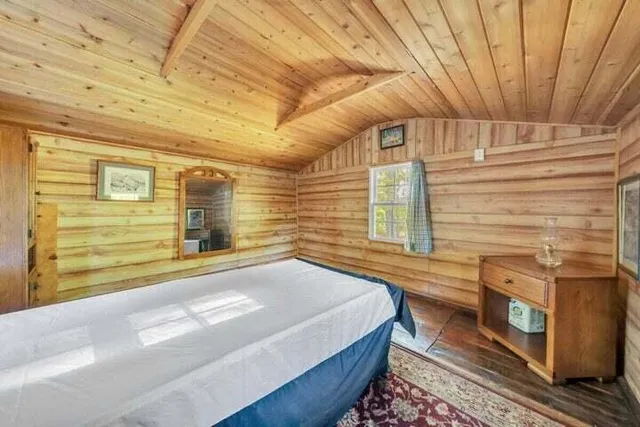 a view of a walk in closet with wooden floor and door