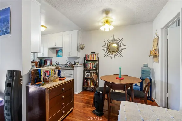 a open dining room with stainless steel appliances a table chairs and a chandelier
