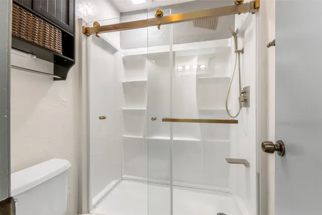 a bathroom with a glass shower door