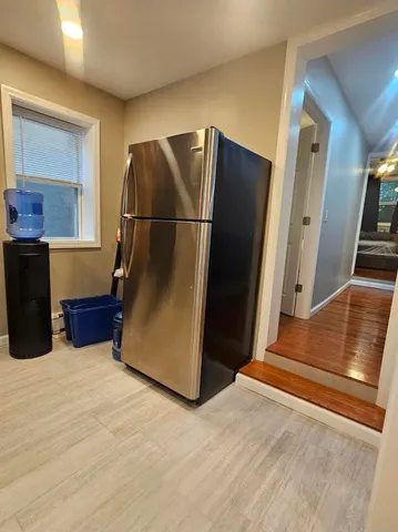 a kitchen with stainless steel appliances granite countertop a refrigerator and a sink