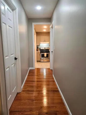 a view of a hallway with wooden floor