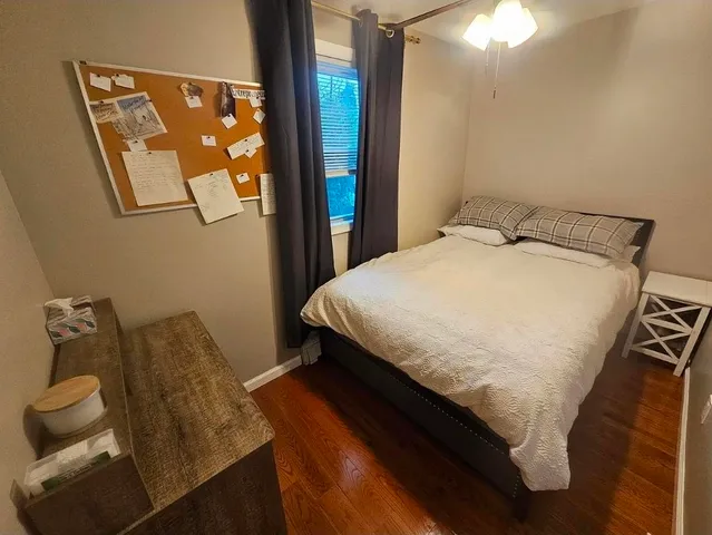 a bed sitting in a bedroom next to a window