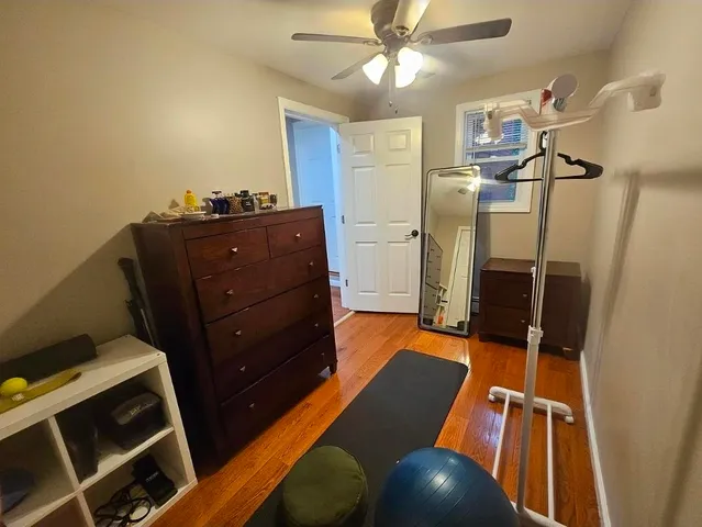 a living room with a furniture and a ceiling fan