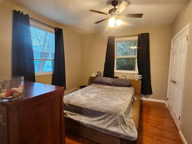 a bed sitting in a bedroom next to a window