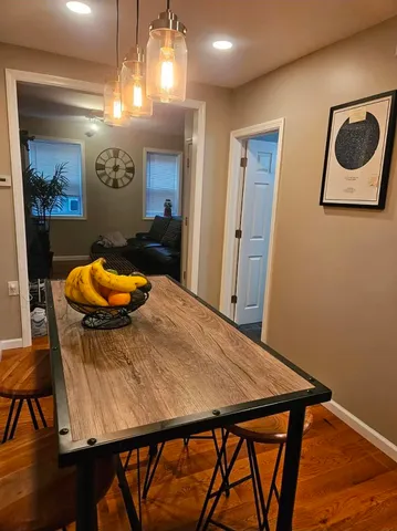 a view of a dining room with furniture and chandelier