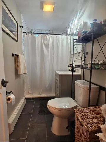 a bathroom with a toilet and a shower