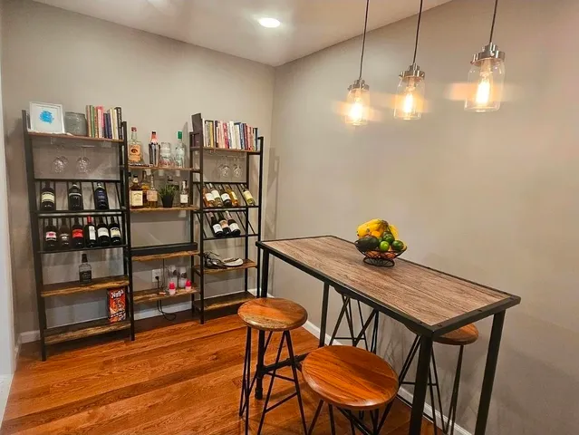 a view of a room with furniture and wooden floor