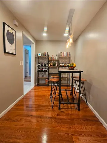 a dining room with furniture and wooden floor