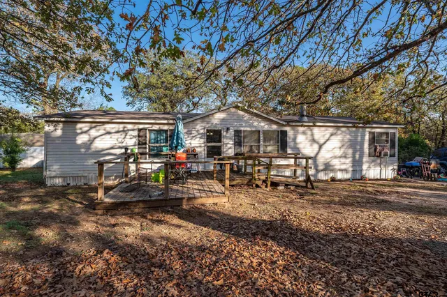 a view of a chair and table in the backyard of the house
