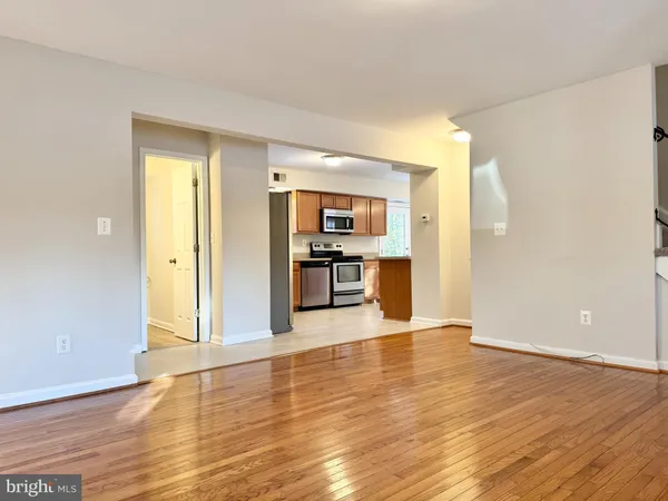 a view of a kitchen with wooden floor and a kitchen
