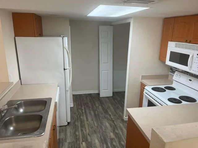 a kitchen with a refrigerator and a sink