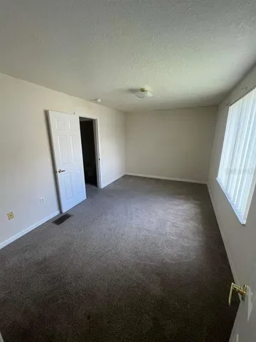 an empty room with a window and stairs