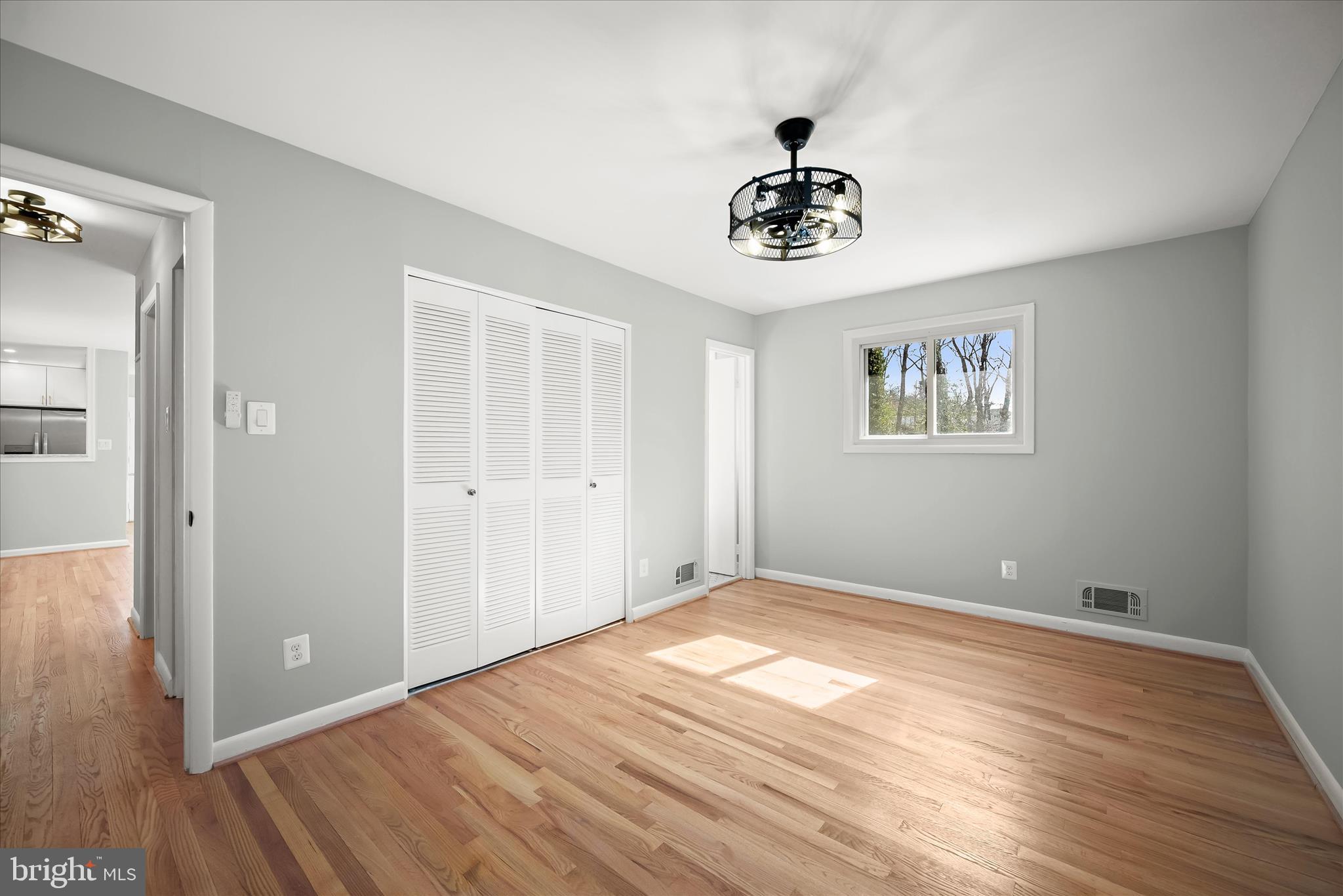 9720 Hedin Drive Silver Spring, MD 20903 - Photo 33 of 79 a view of an empty room with wooden floor and a ceiling fan