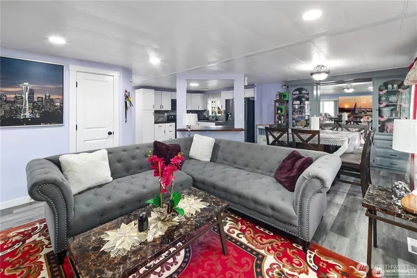 a living room with furniture and kitchen view